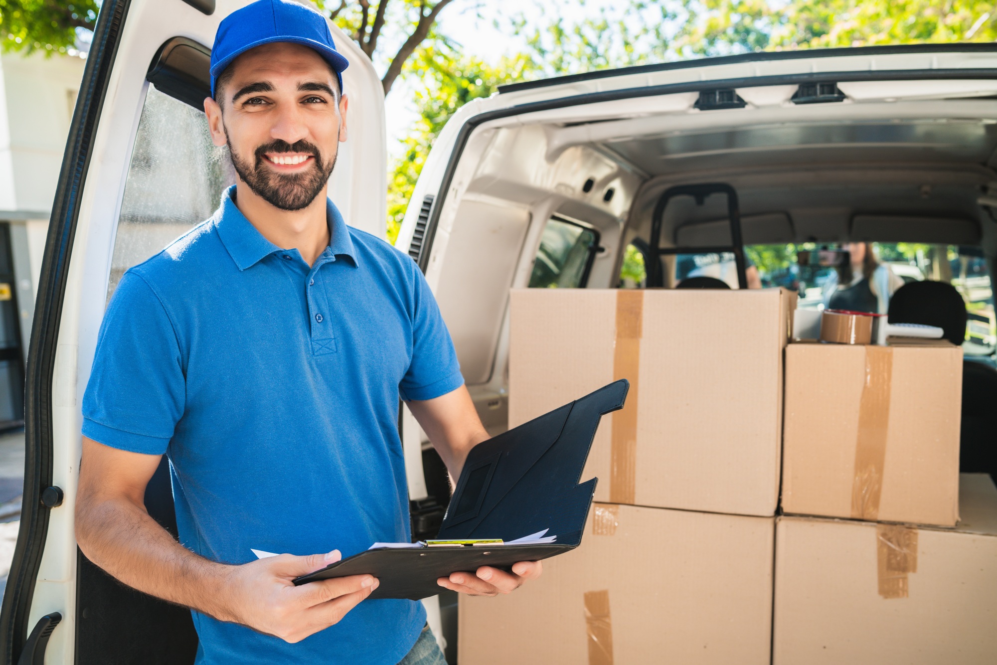 Delivery man checking the products with checklist.